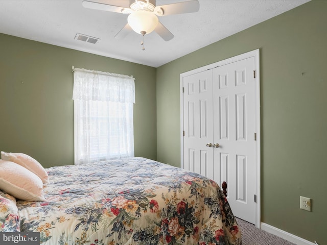 bedroom featuring ceiling fan, carpet, and a closet