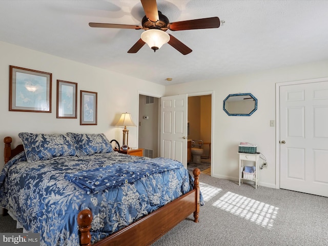 carpeted bedroom featuring ensuite bath and ceiling fan