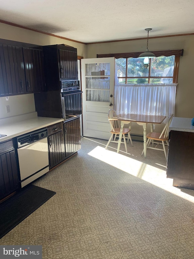 kitchen with crown molding, a textured ceiling, dishwasher, decorative light fixtures, and black oven