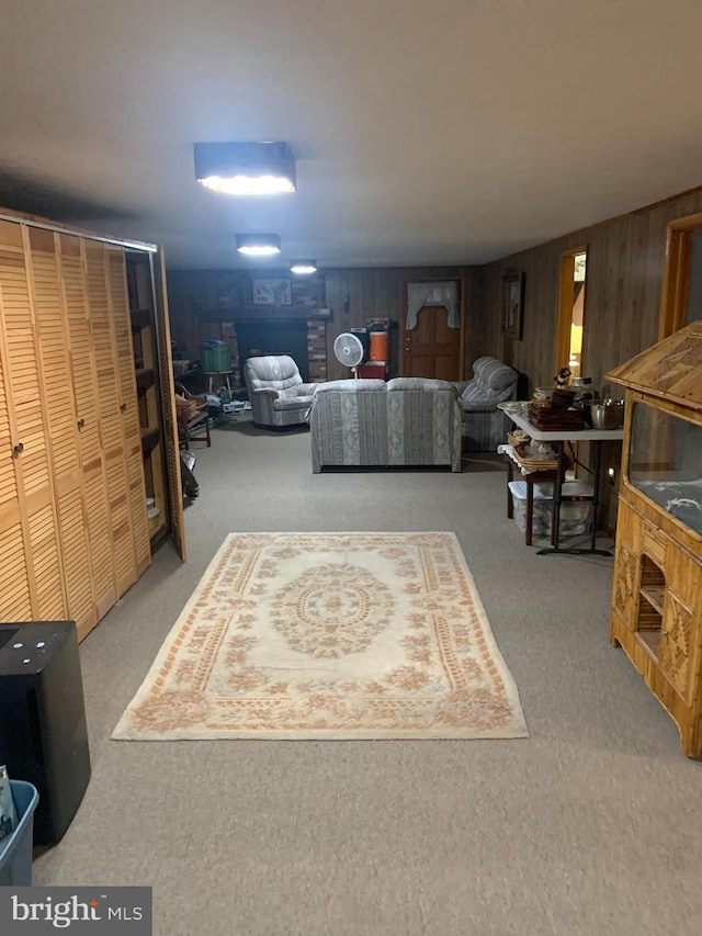 living room featuring carpet and wooden walls