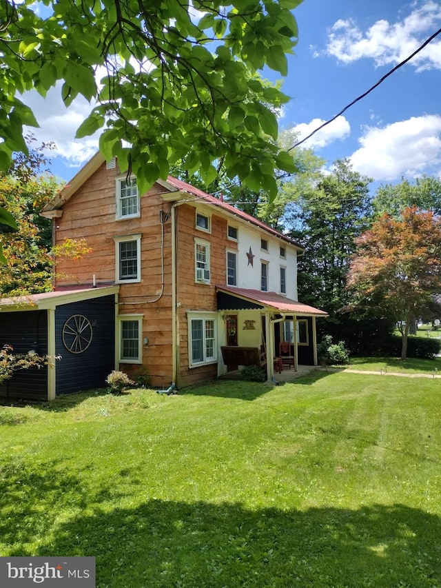 rear view of house with a yard