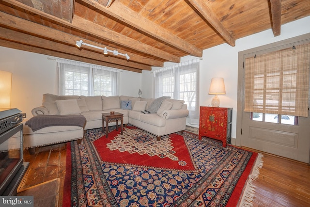 living room featuring wood ceiling, track lighting, beam ceiling, and hardwood / wood-style flooring