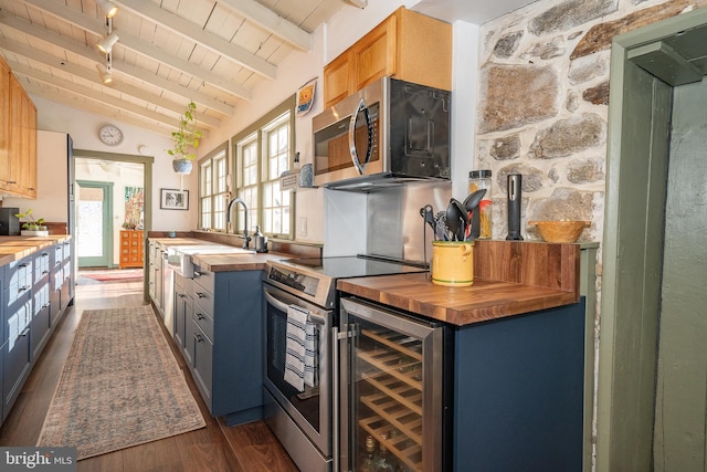 kitchen with wood counters, lofted ceiling with beams, sink, wood ceiling, and stainless steel appliances