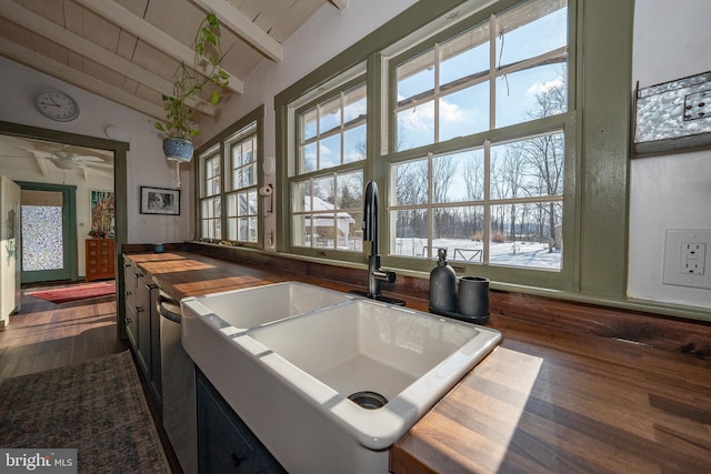 kitchen with wood ceiling, a healthy amount of sunlight, sink, and vaulted ceiling with beams