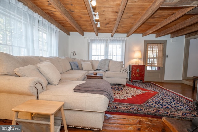 living room featuring hardwood / wood-style flooring, wooden ceiling, and beamed ceiling