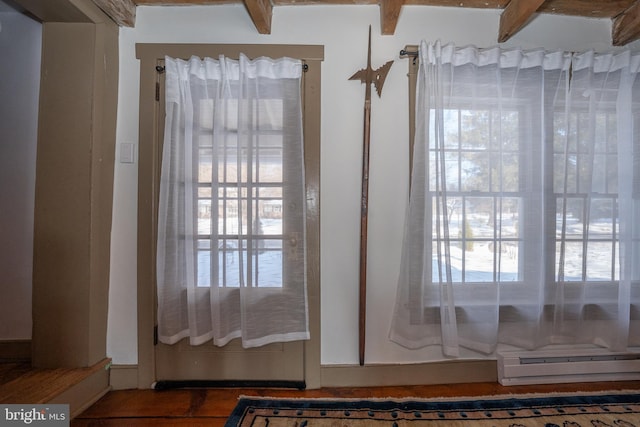 doorway featuring beamed ceiling