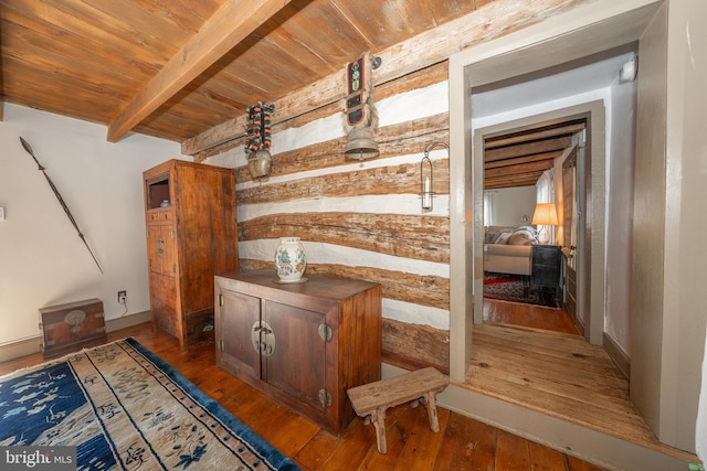 bar with beam ceiling, wood-type flooring, and wooden ceiling