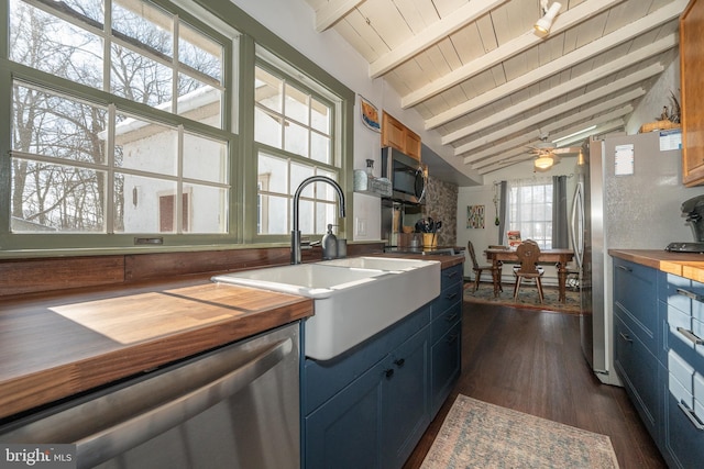 kitchen featuring sink, wood ceiling, appliances with stainless steel finishes, lofted ceiling with beams, and dark hardwood / wood-style flooring