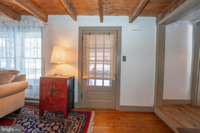 interior space with plenty of natural light, wooden ceiling, and beam ceiling