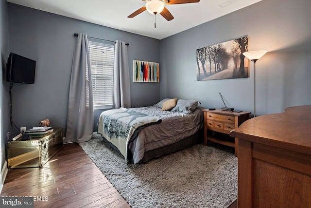 bedroom featuring ceiling fan and dark hardwood / wood-style flooring