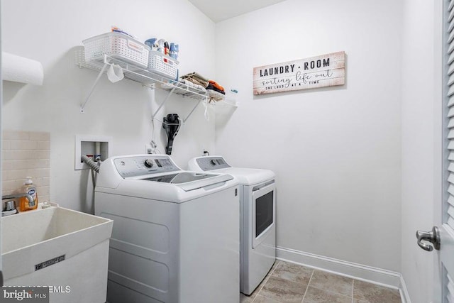 washroom with sink and washing machine and dryer