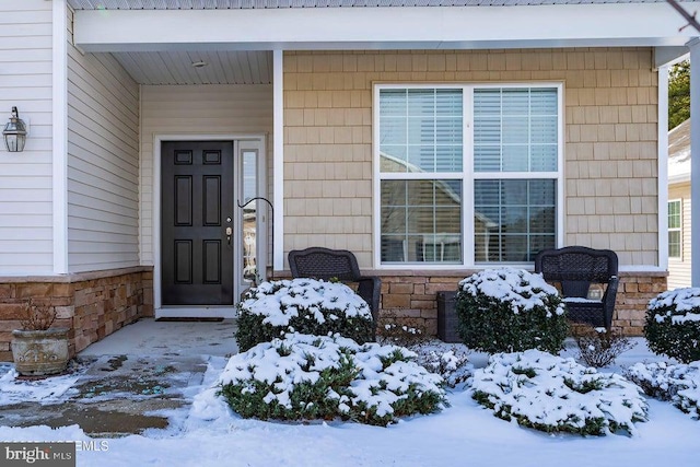 view of snow covered property entrance