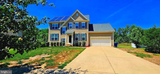 view of front facade with a garage and solar panels