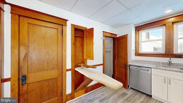 interior space featuring sink, a paneled ceiling, and light wood-type flooring