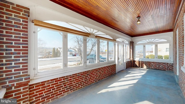 unfurnished sunroom with wooden ceiling