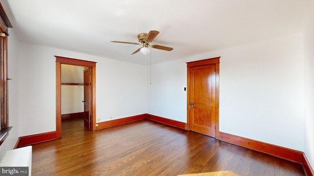 unfurnished bedroom with ceiling fan and dark hardwood / wood-style flooring