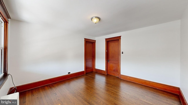 unfurnished room with wood-type flooring