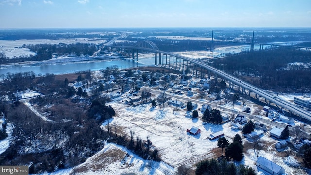 snowy aerial view featuring a water view