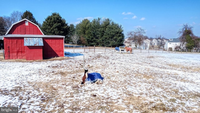 snowy yard with an outbuilding