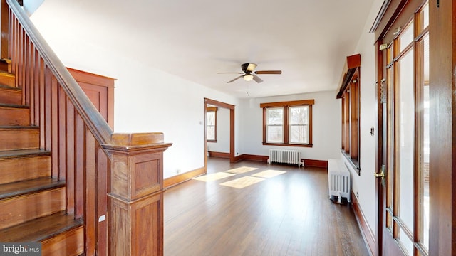 entrance foyer featuring hardwood / wood-style floors, radiator heating unit, and ceiling fan