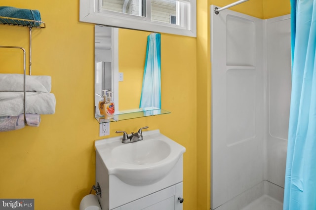 bathroom with vanity and curtained shower