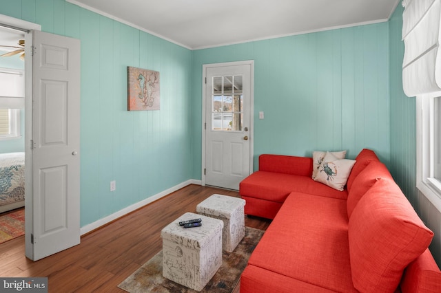 living room with ceiling fan, ornamental molding, a wealth of natural light, and dark hardwood / wood-style flooring