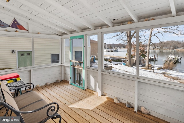 sunroom featuring a healthy amount of sunlight, a water view, vaulted ceiling with beams, and wooden ceiling