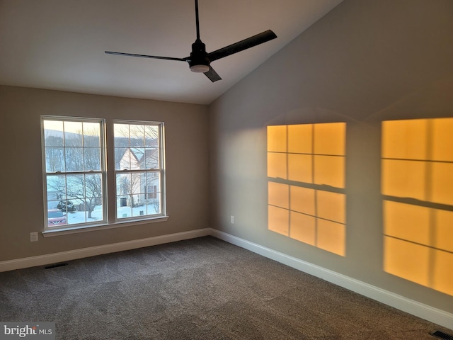 carpeted empty room with vaulted ceiling and ceiling fan