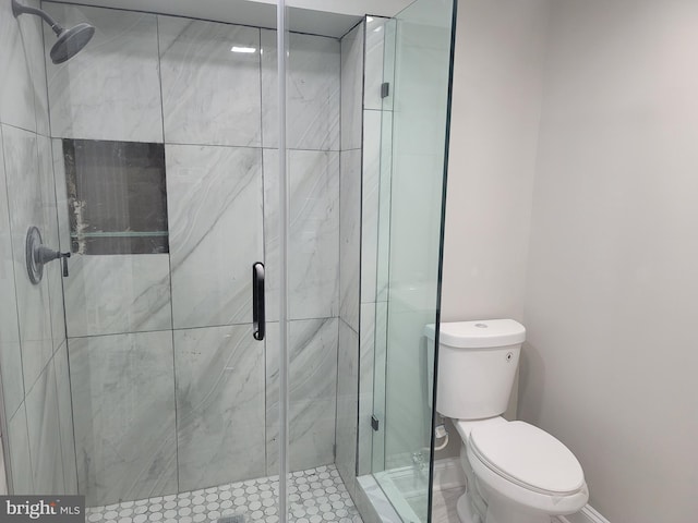 bathroom with an enclosed shower and toilet