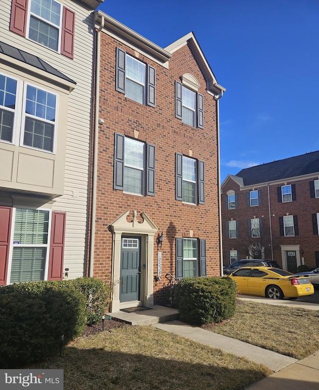 view of property featuring brick siding