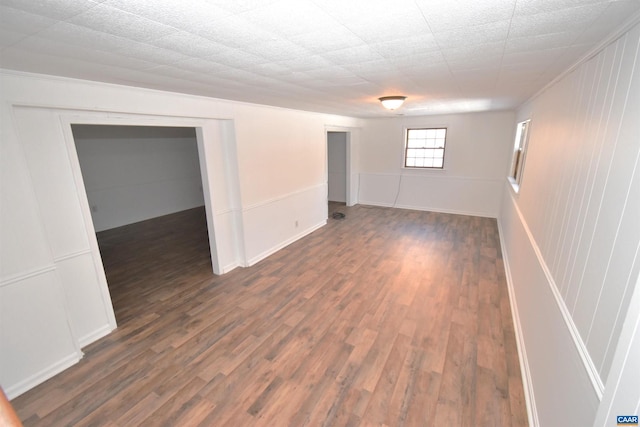 basement with dark hardwood / wood-style floors