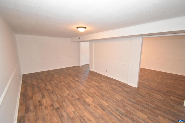 basement with dark hardwood / wood-style floors