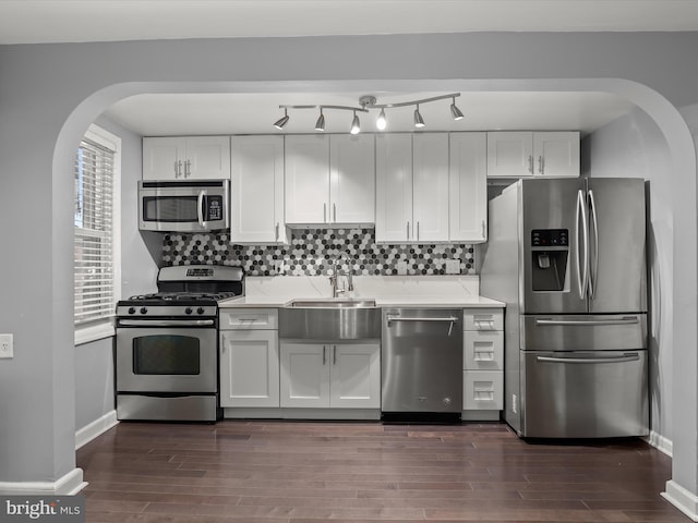 kitchen with white cabinetry, decorative backsplash, and appliances with stainless steel finishes