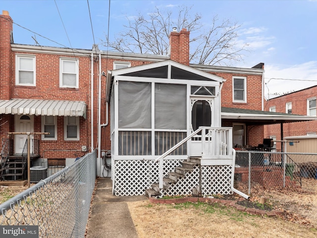 back of house featuring central AC