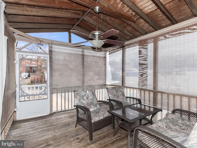 sunroom with vaulted ceiling with beams and ceiling fan