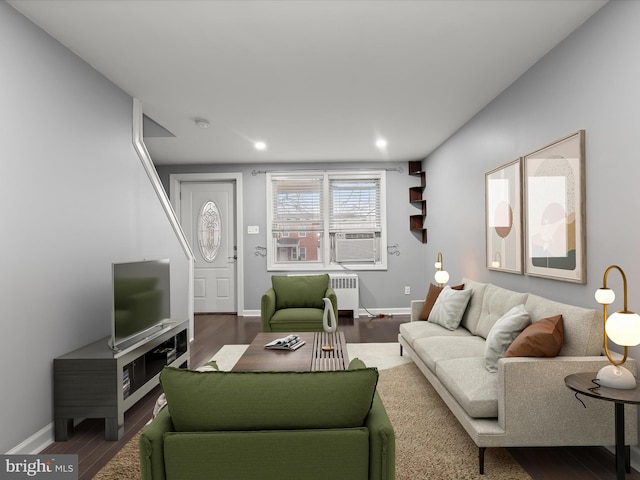 living room featuring dark wood-type flooring, radiator heating unit, and cooling unit