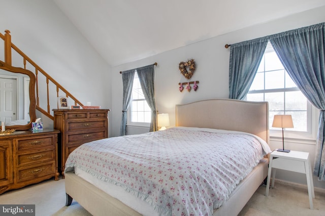 carpeted bedroom featuring vaulted ceiling