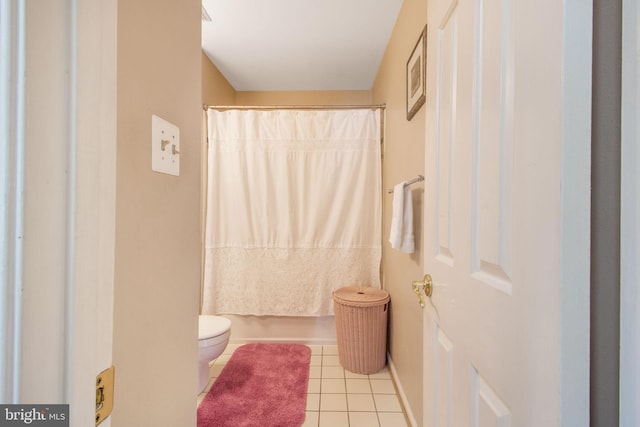 bathroom with tile patterned flooring and toilet