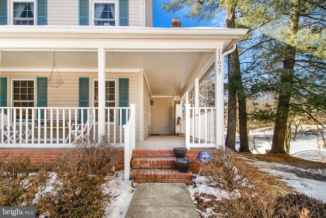 view of snow covered property entrance