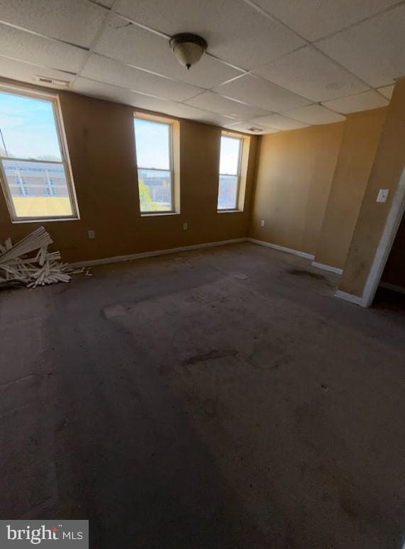 unfurnished room with a paneled ceiling