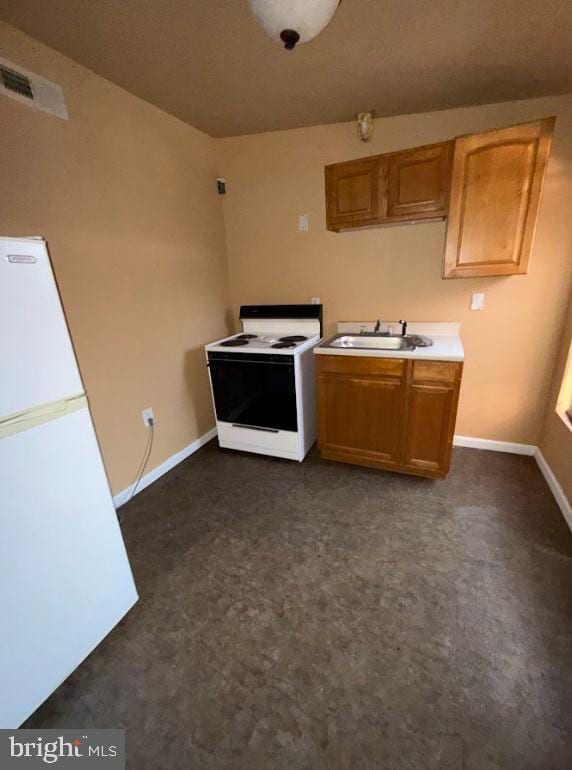 kitchen featuring sink and white appliances