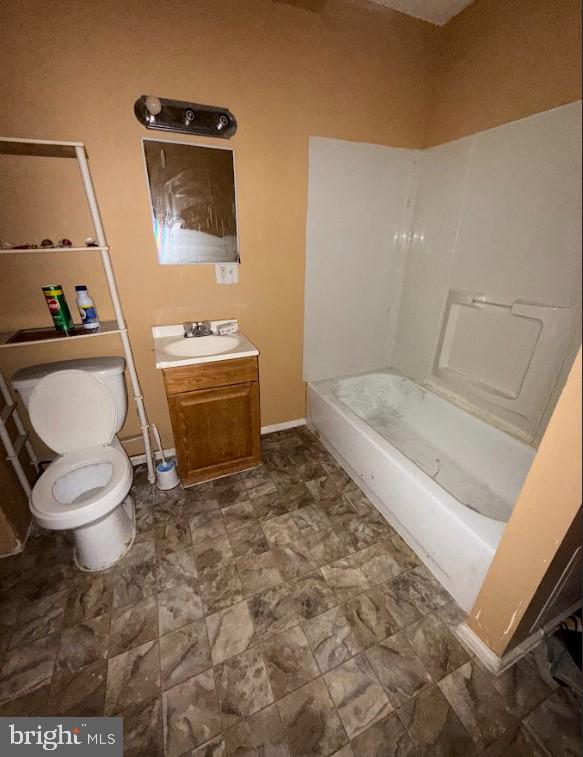 full bathroom with vanity, toilet, and washtub / shower combination