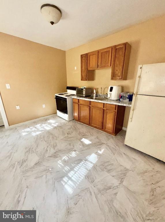 kitchen with sink and white appliances