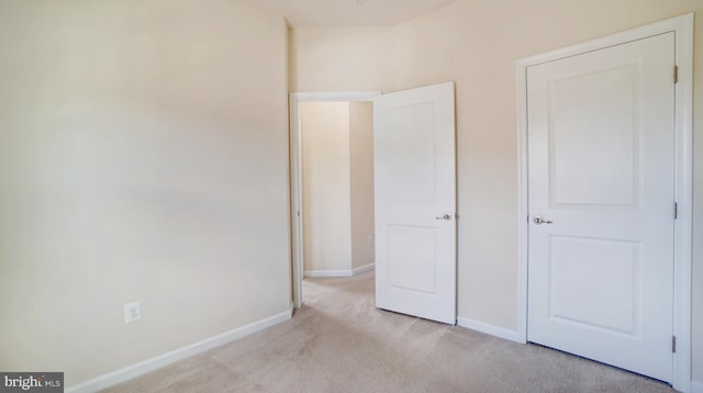 unfurnished bedroom with light carpet