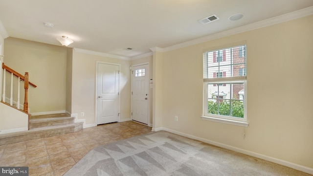 entryway with crown molding and plenty of natural light