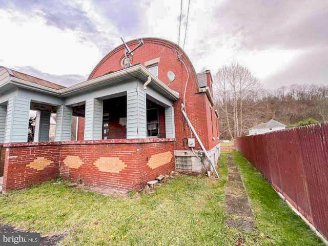 view of side of property with a yard