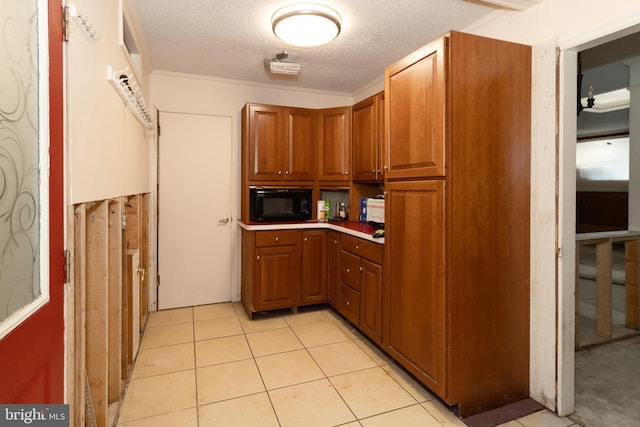 kitchen featuring light tile patterned floors and a textured ceiling