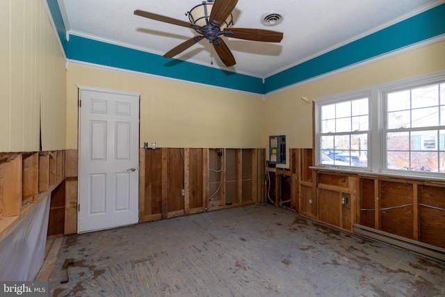 spare room featuring crown molding, electric panel, ceiling fan, and a baseboard radiator