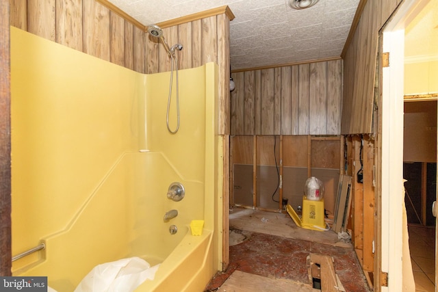 bathroom featuring wooden walls and tub / shower combination