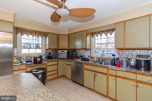 kitchen featuring stainless steel appliances, ornamental molding, sink, and decorative backsplash